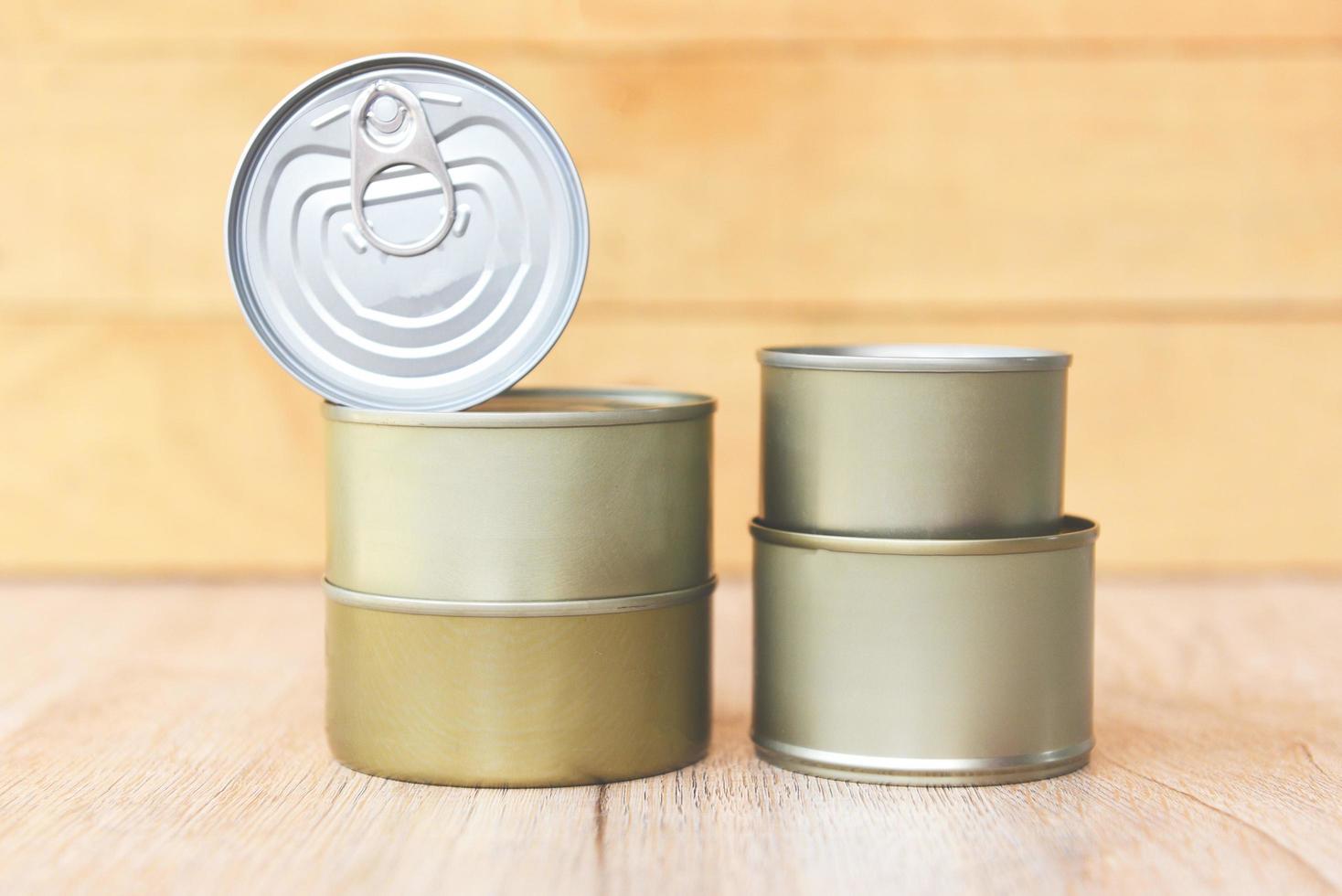 Various canned food in metal cans on wooden background canned goods non perishable food storage goods in kitchen home or for donations photo