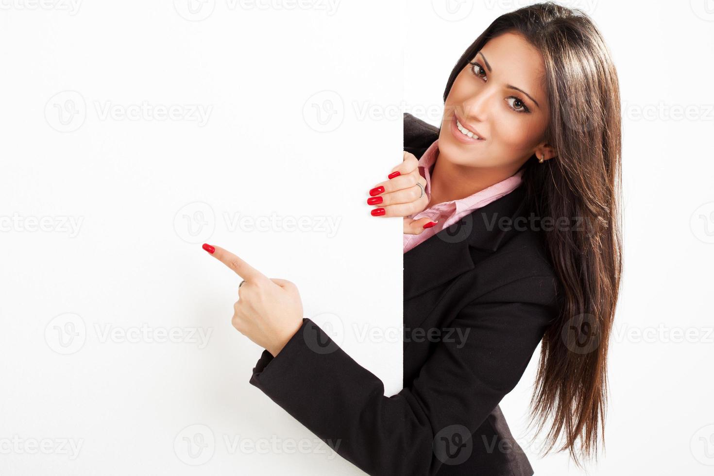 Businesswoman pointing on board photo