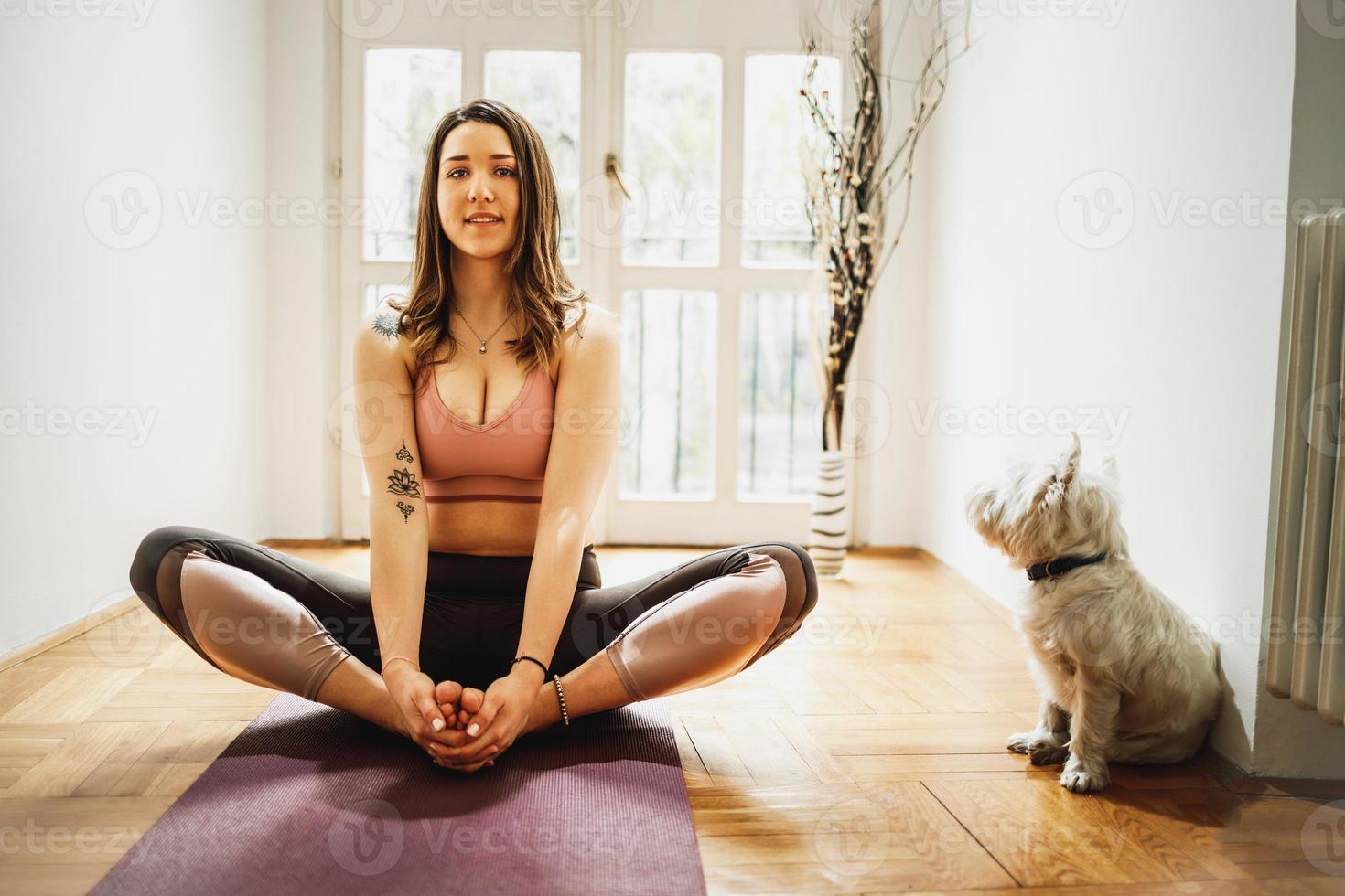 Woman Doing Yoga With Her Dog photo