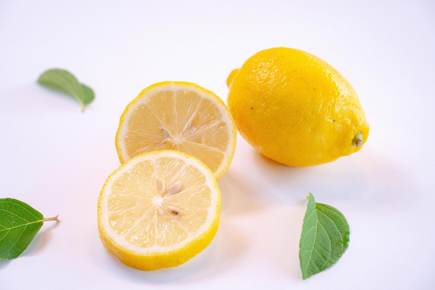 Creative layout made of lemon and leaves. Flat lay. Food concept. Lemon on white background photo