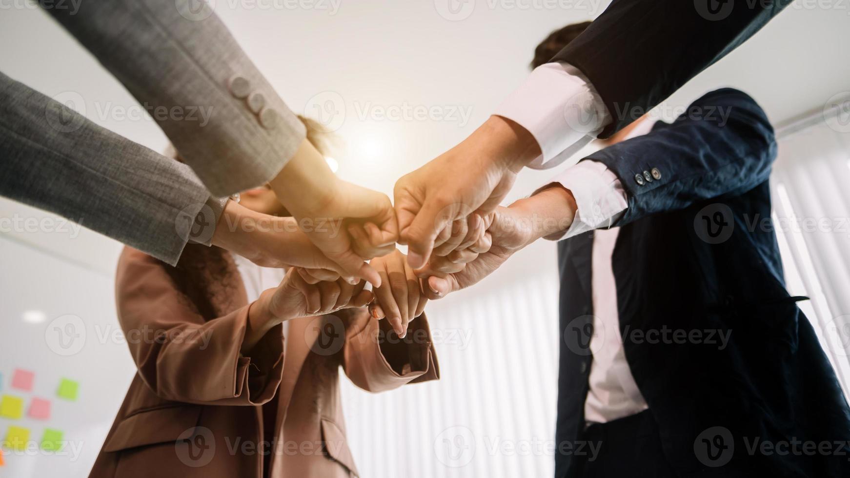 Close up on hands of business people join together their hands together on unity concept photo