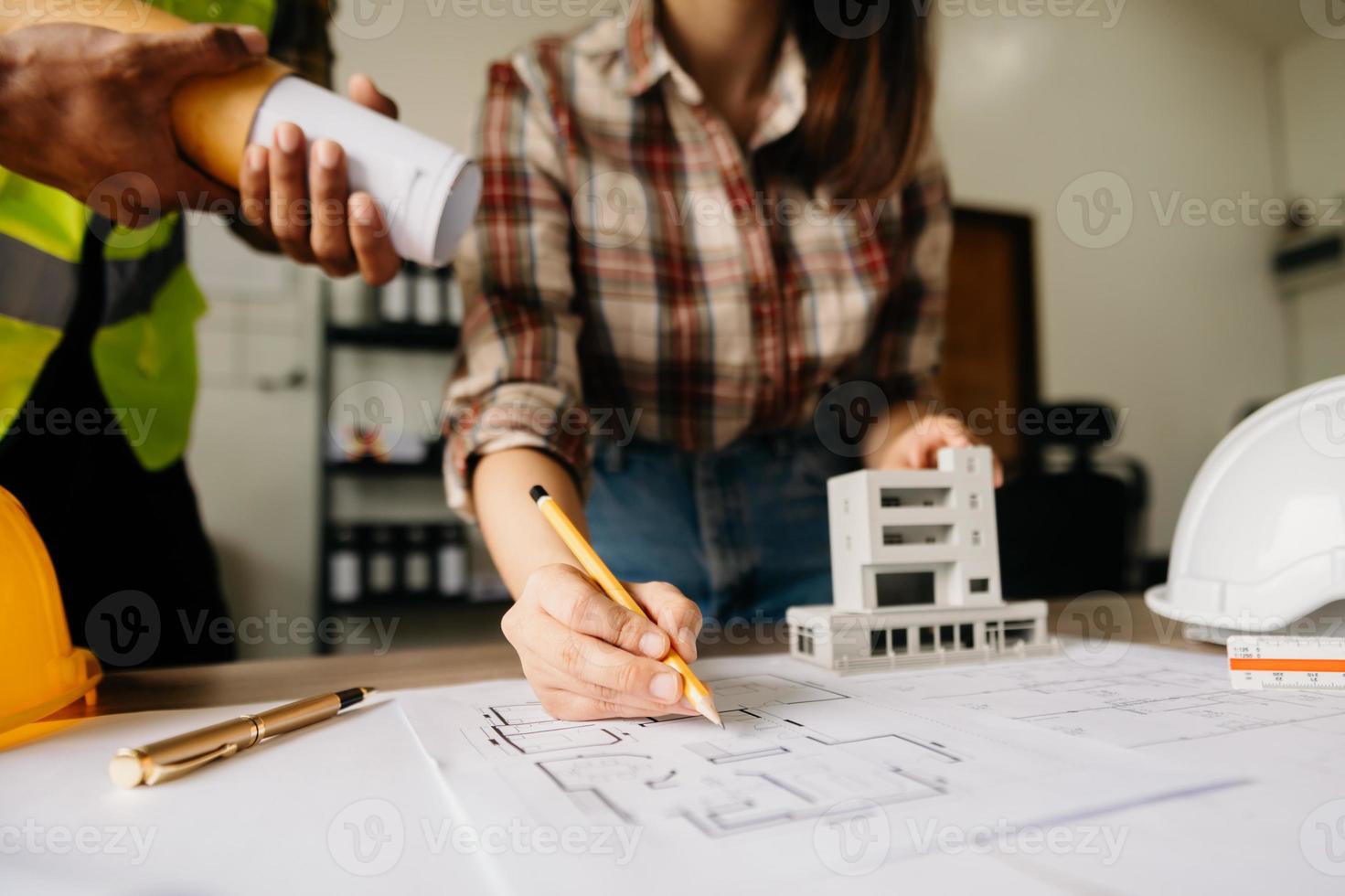 Engineer people meeting working in modern office for discussing, engineering .Hands of Engineer working on blueprint Construction concept. photo