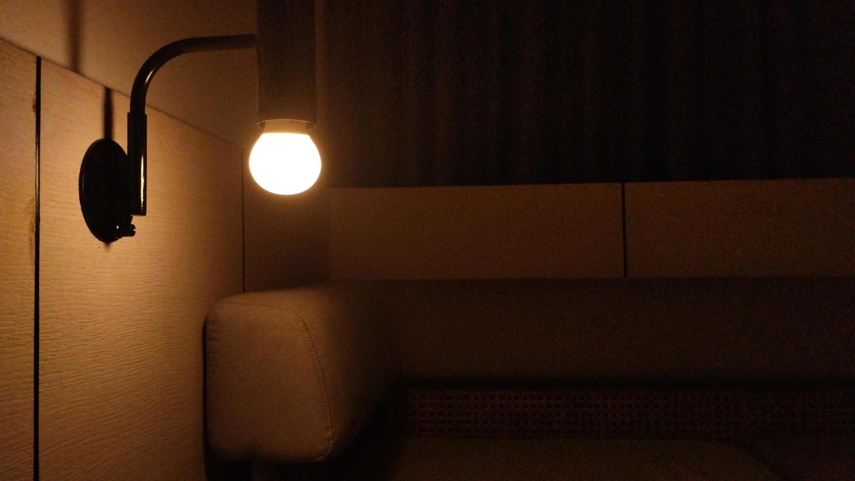 dark hotel room with yellow bulb light photo