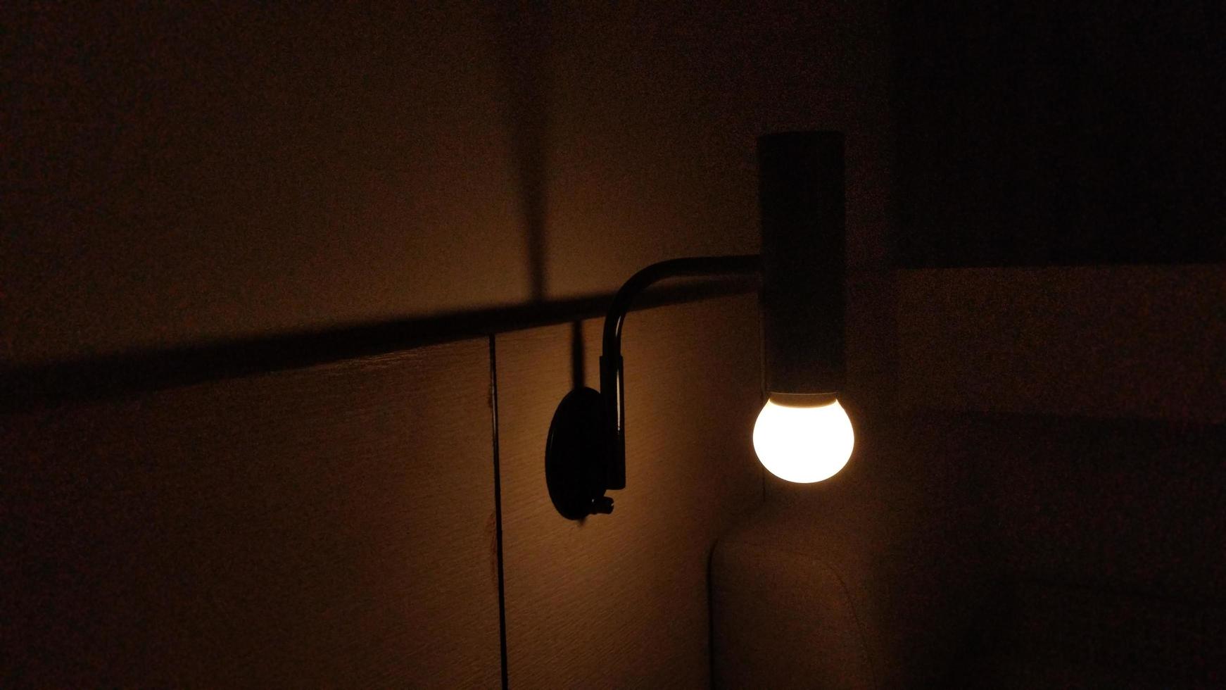 dark hotel room with yellow bulb light photo