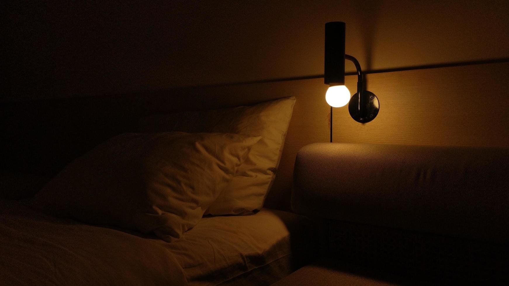 dark hotel room with yellow bulb light photo