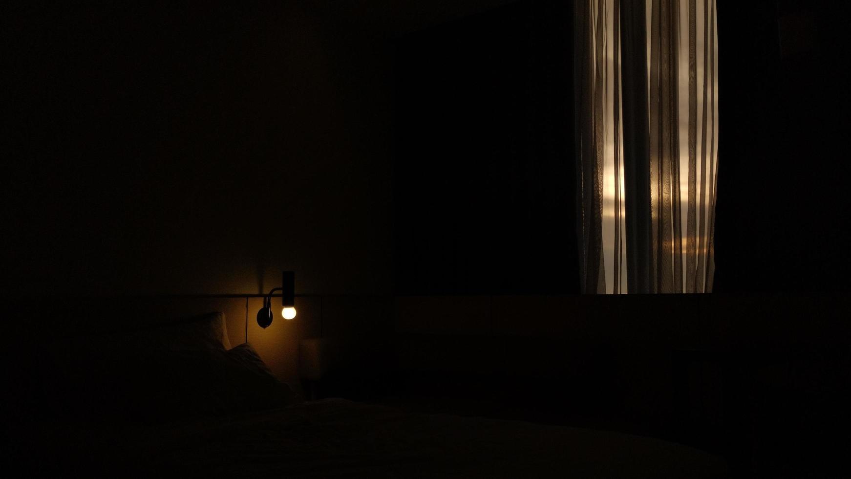 dark hotel room with yellow bulb light photo