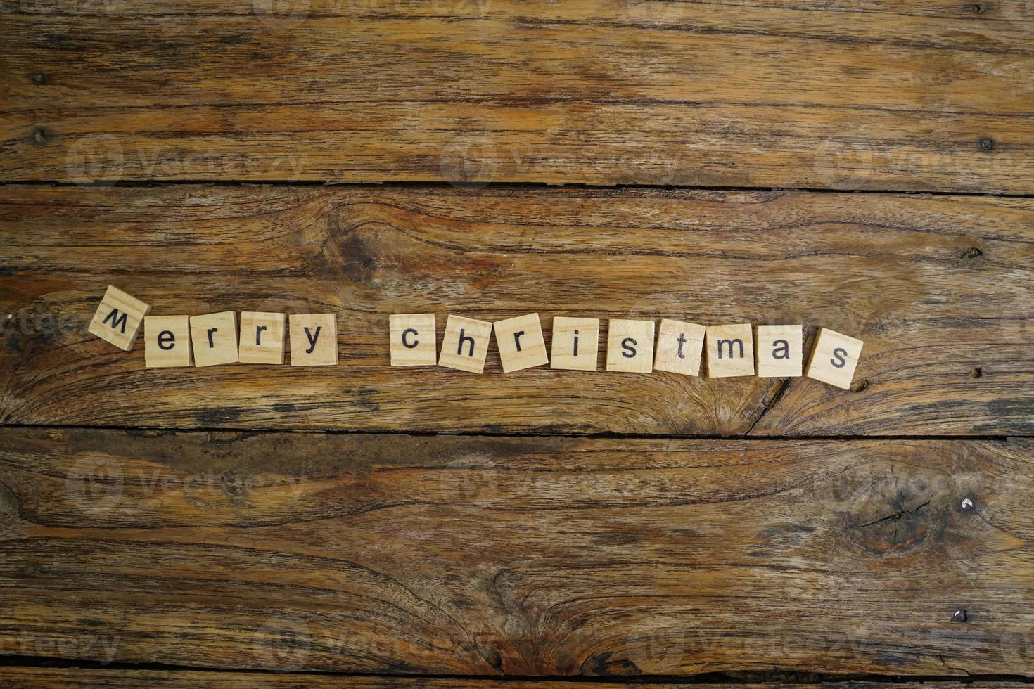 Merry Christmas.  wooden letters merry christmas word  on old wooden background photo