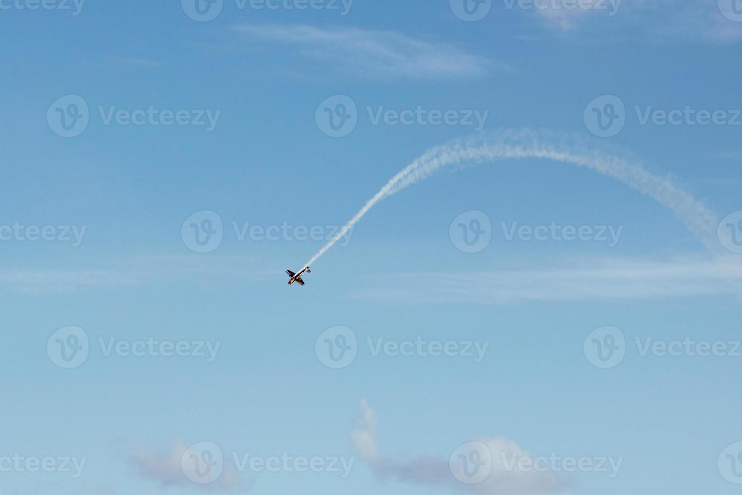 Airplane make smoke trails and loop. Clear blue sky and plane 14239013