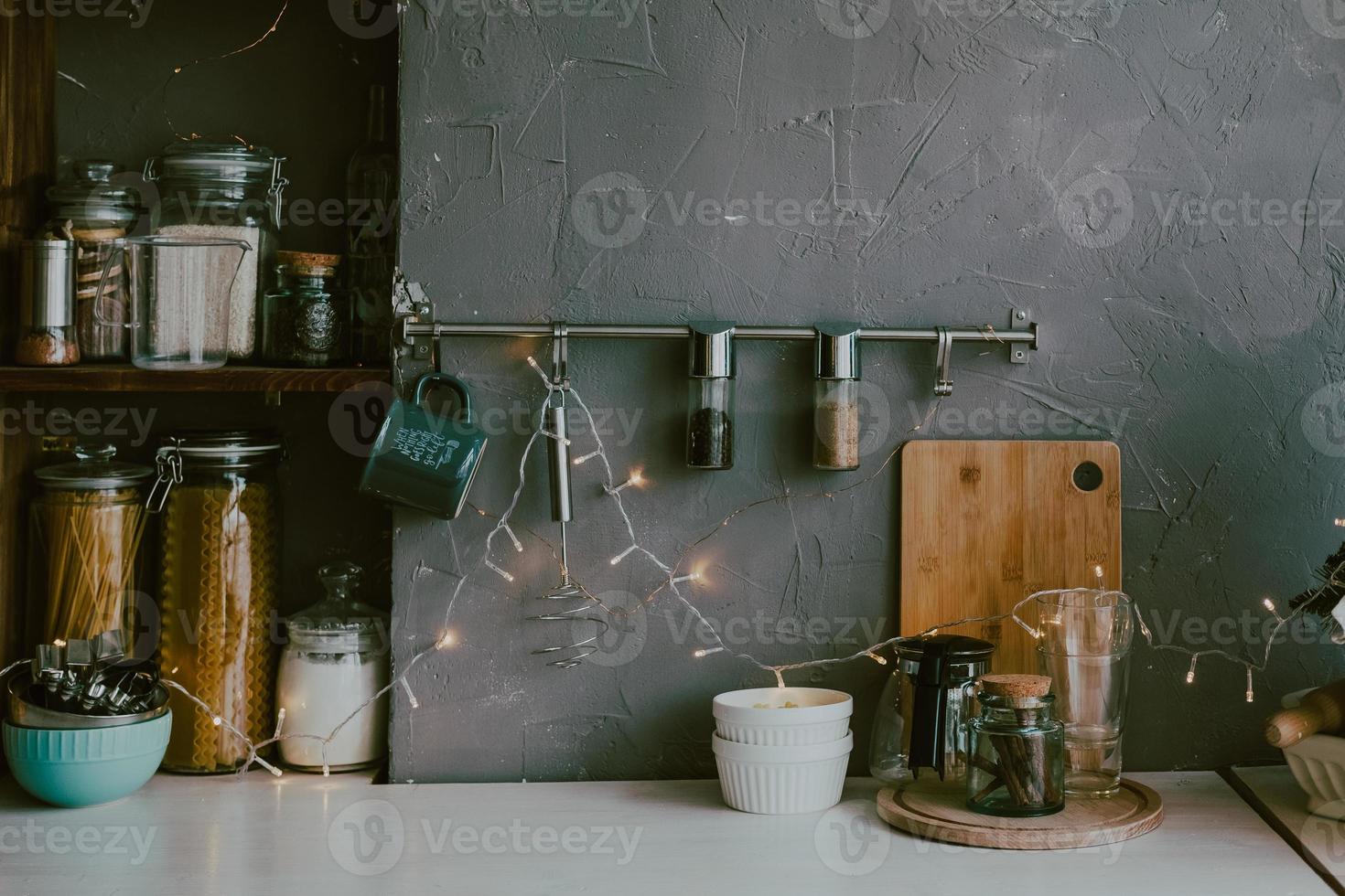 kitchen decorated with Christmas garlands. Kitchen corner with spices and containers. Hygge style kitchen photo