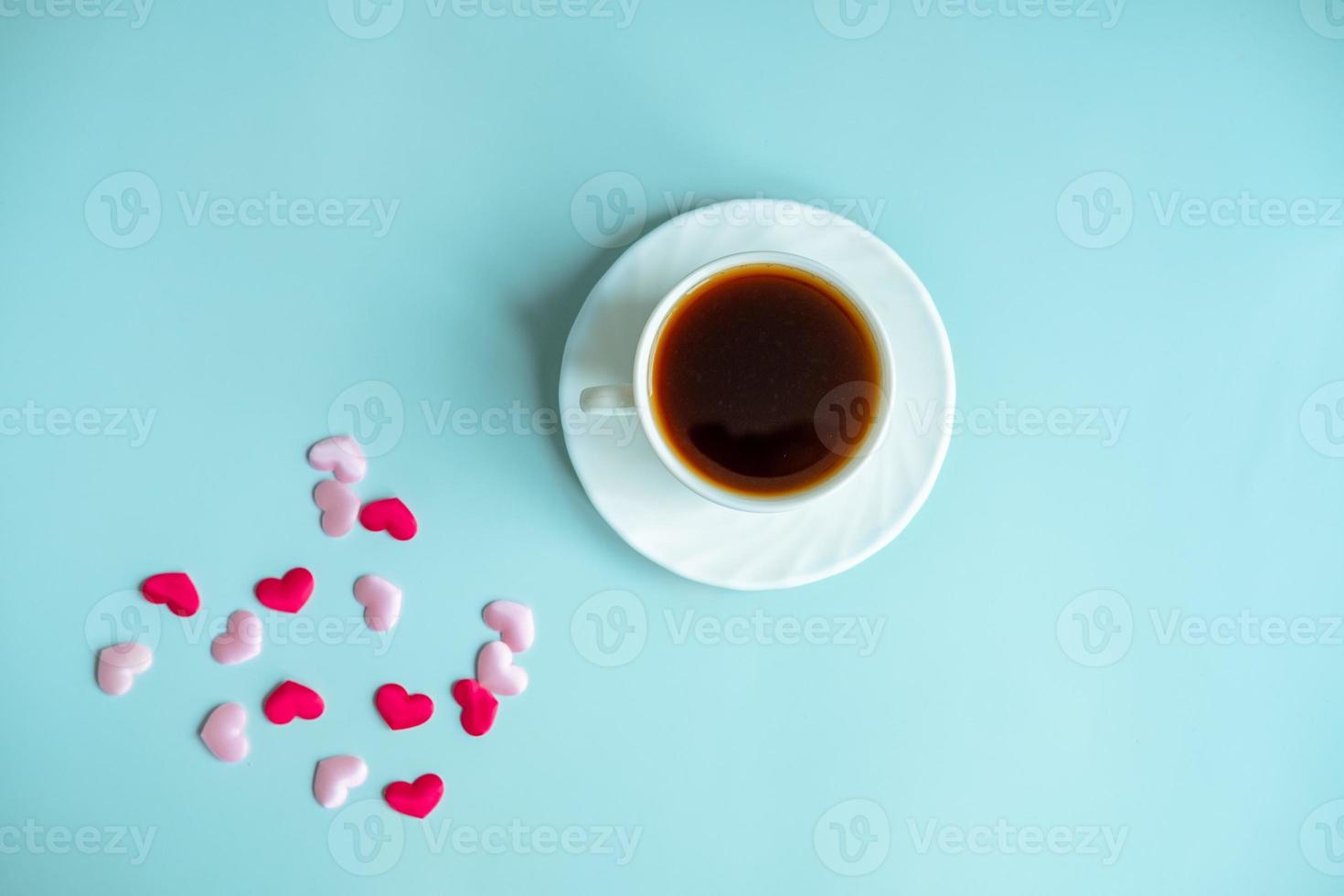 Valentine's blue background concept with coffee cup and hearts photo