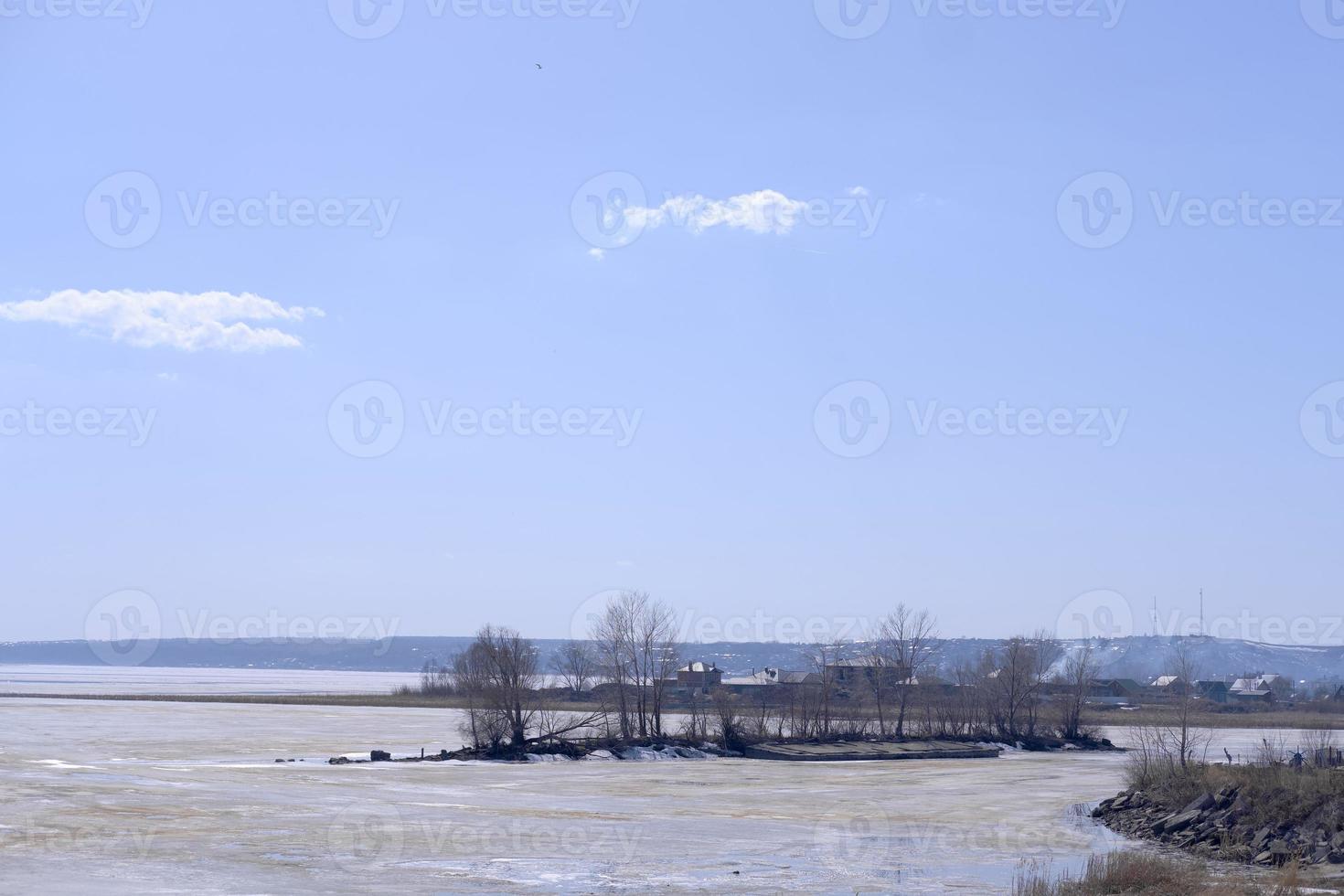 panorama invernal del volga congelado contra el fondo del cielo azul y las nubes en los brillantes rayos de la luz del día. foto