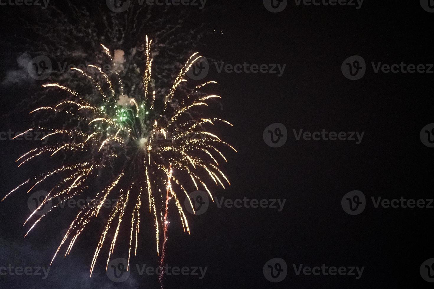 fireworks and salute lights on the background of the black sky. Christmas fireworks in the night sky. New Year celebration, copy space photo