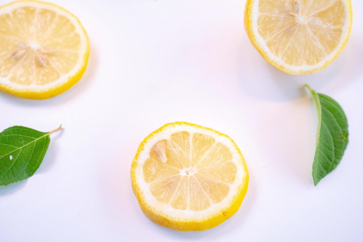 Creative layout made of lemon and leaves. Flat lay. Food concept. Lemon on white background photo