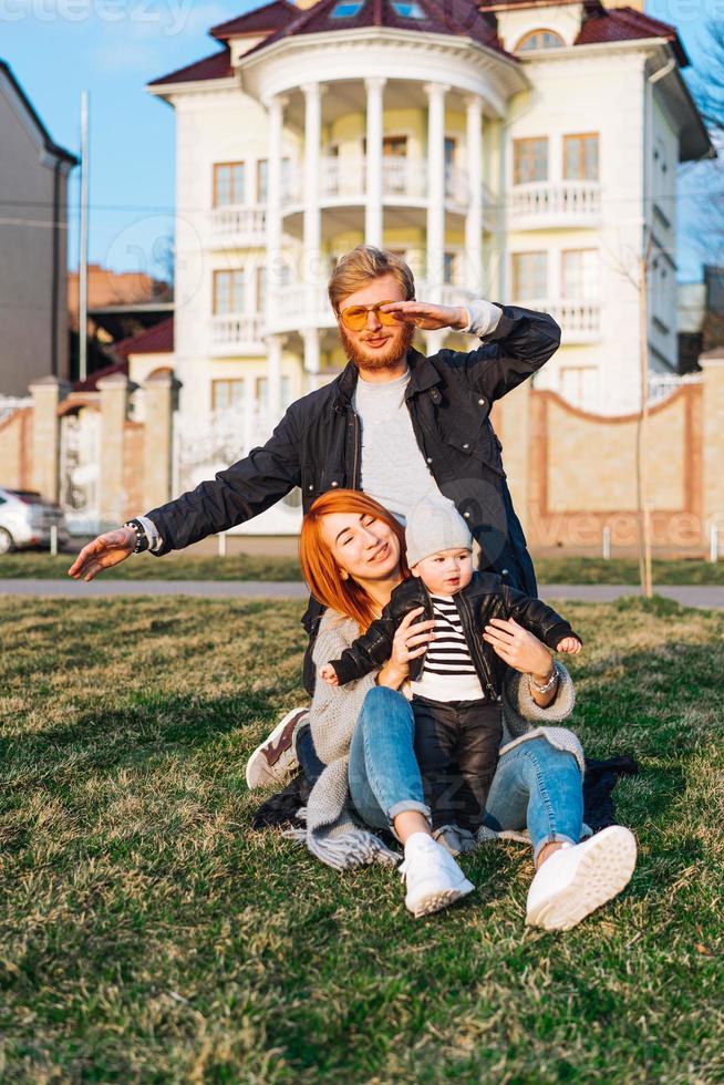 happy mom dad and son hugging in the park photo