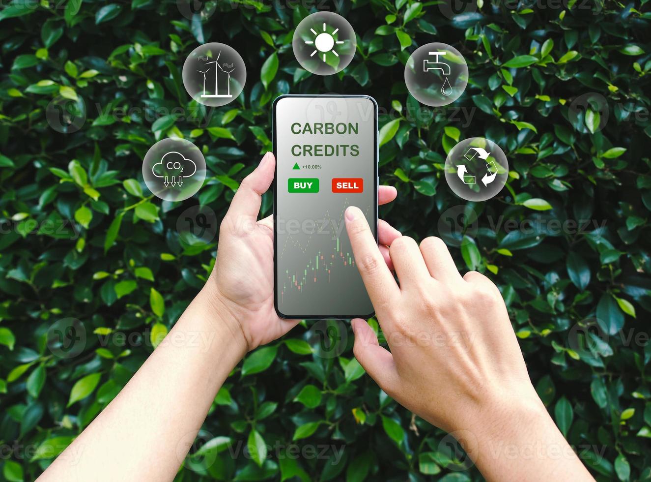 Trader using smartphone to trade carbon credits on application. Net zero emission, Clean technology, Renewable energy concept. photo