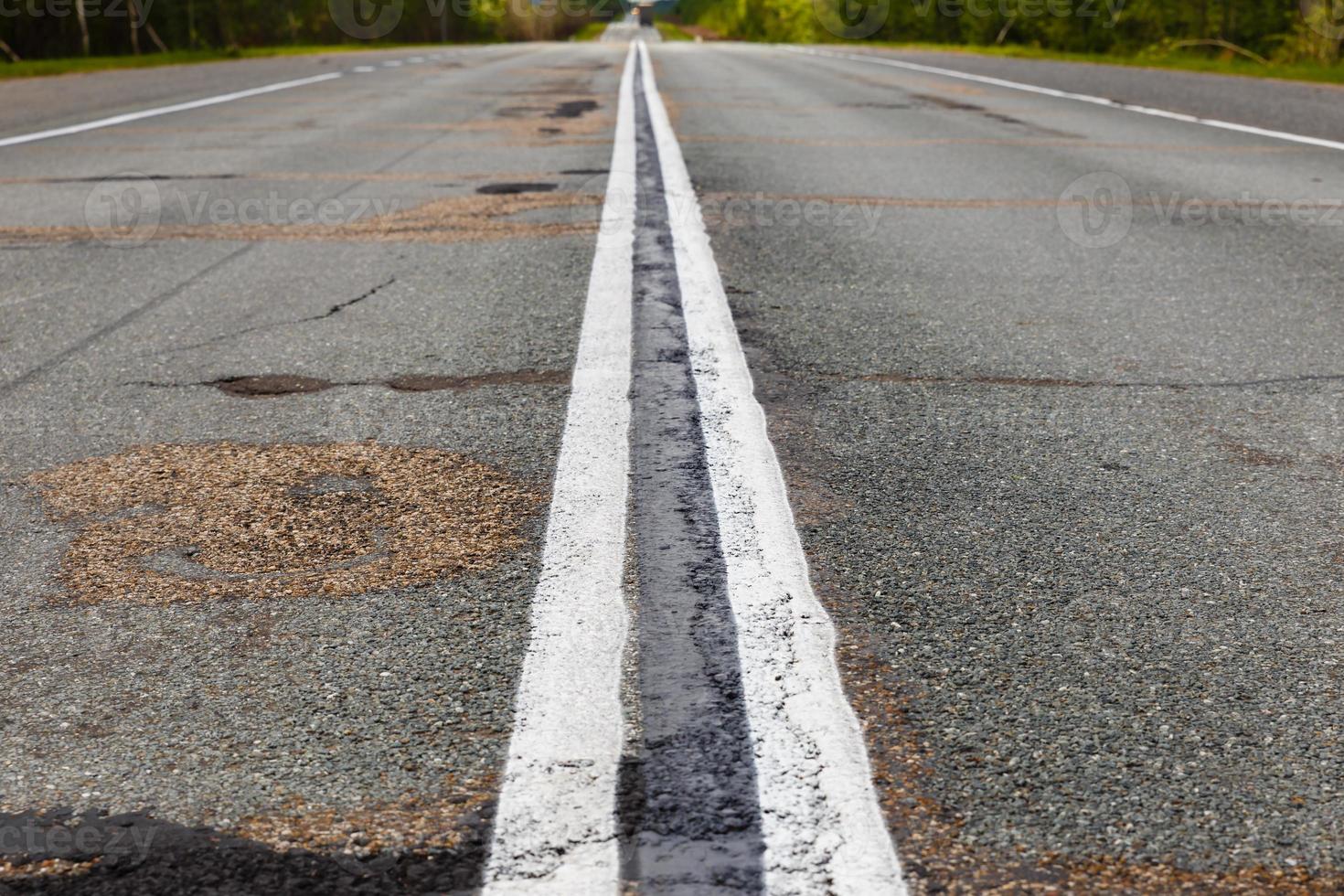 white double continuous strip on the asphalt photo