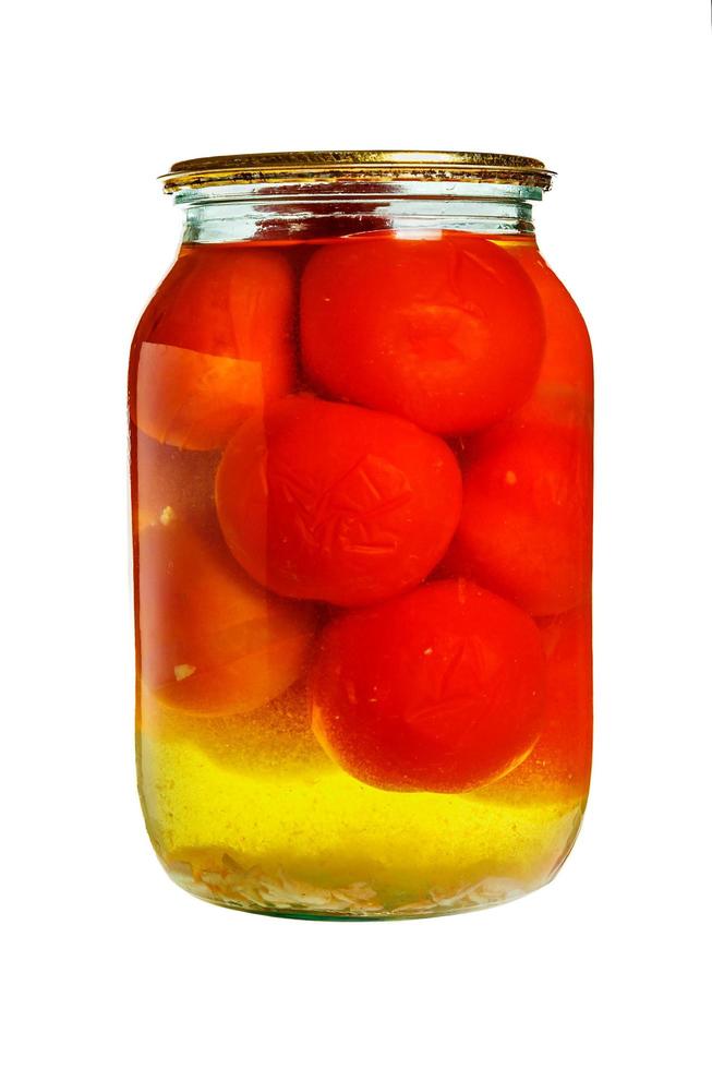 Pickled tomatoes in a glass jar isolated on white background. canned foods photo