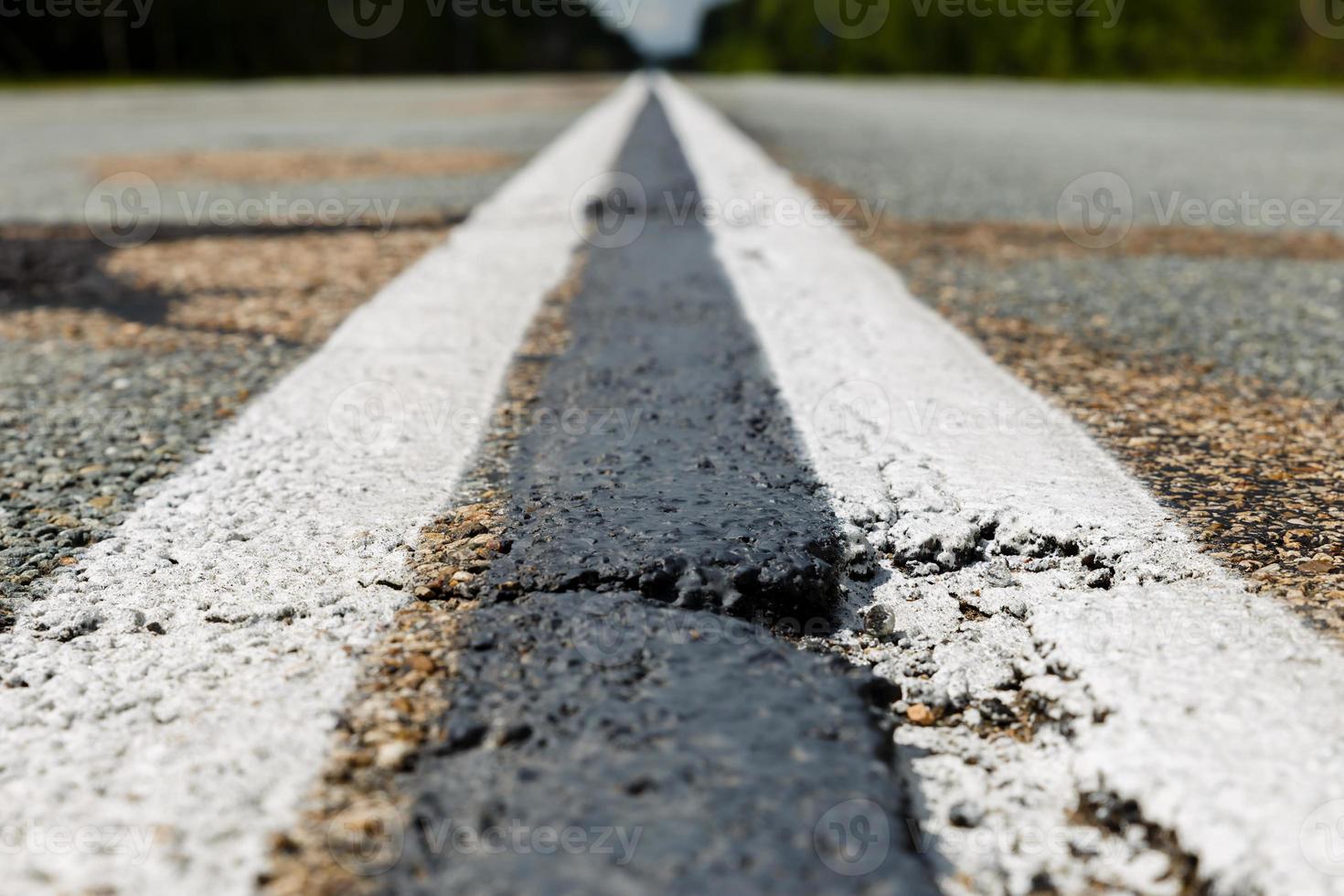 white double continuous strip on the Asphalt road photo