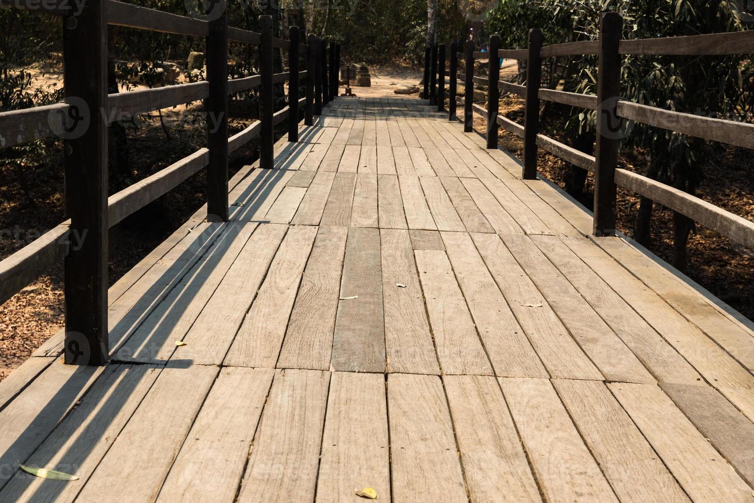 old wooden bridge in deep forest, natural vintage background photo