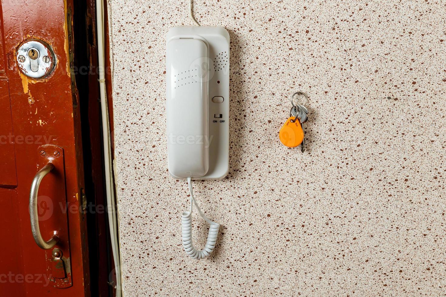 keys and white intercom on the wall of the apartment. photo