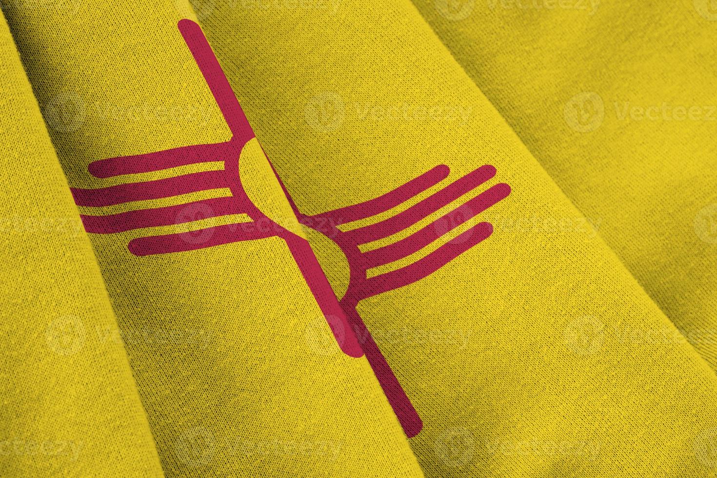 New Mexico US state flag with big folds waving close up under the studio light indoors. The official symbols and colors in banner photo