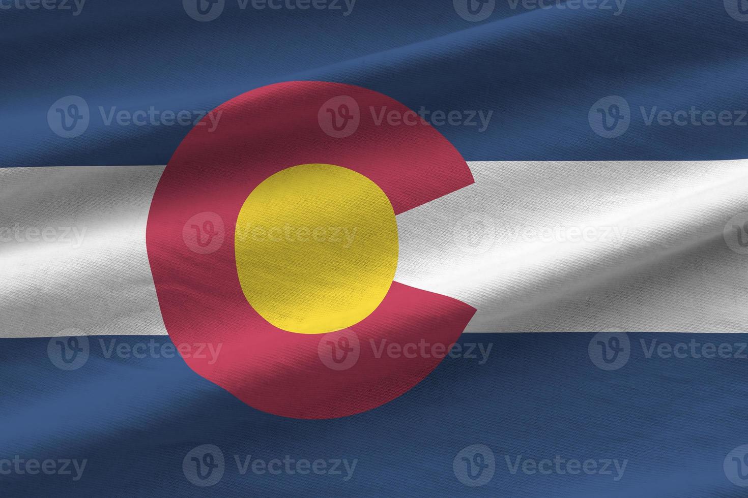 Colorado US state flag with big folds waving close up under the studio light indoors. The official symbols and colors in banner photo