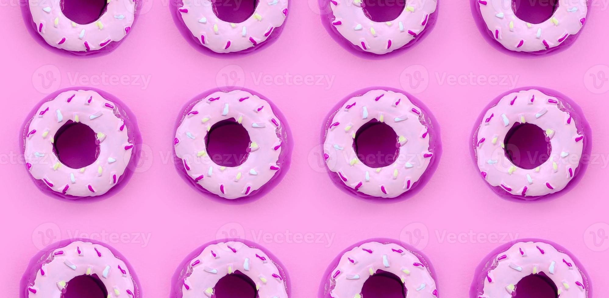 Many small plastic donuts lies on a pastel colorful background. Flat lay minimal pattern. Top view photo