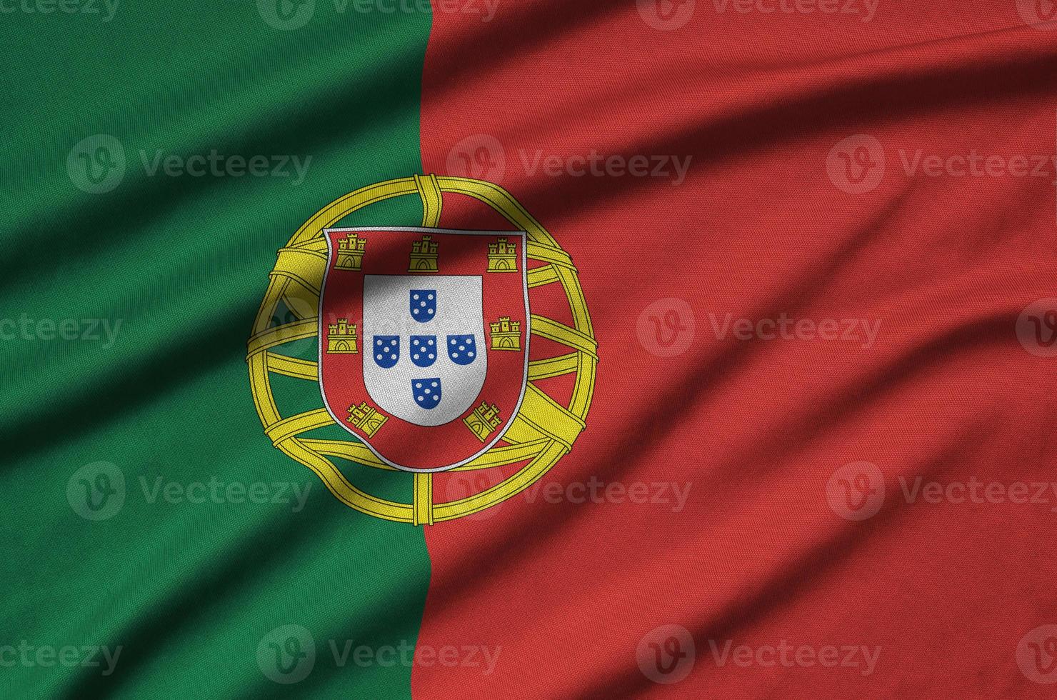 Portugal flag  is depicted on a sports cloth fabric with many folds. Sport team banner photo