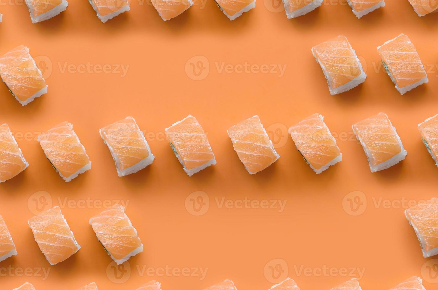 Philadelphia rolls with salmon on orange background. Minimalism top view flat lay pattern with Japanese food photo
