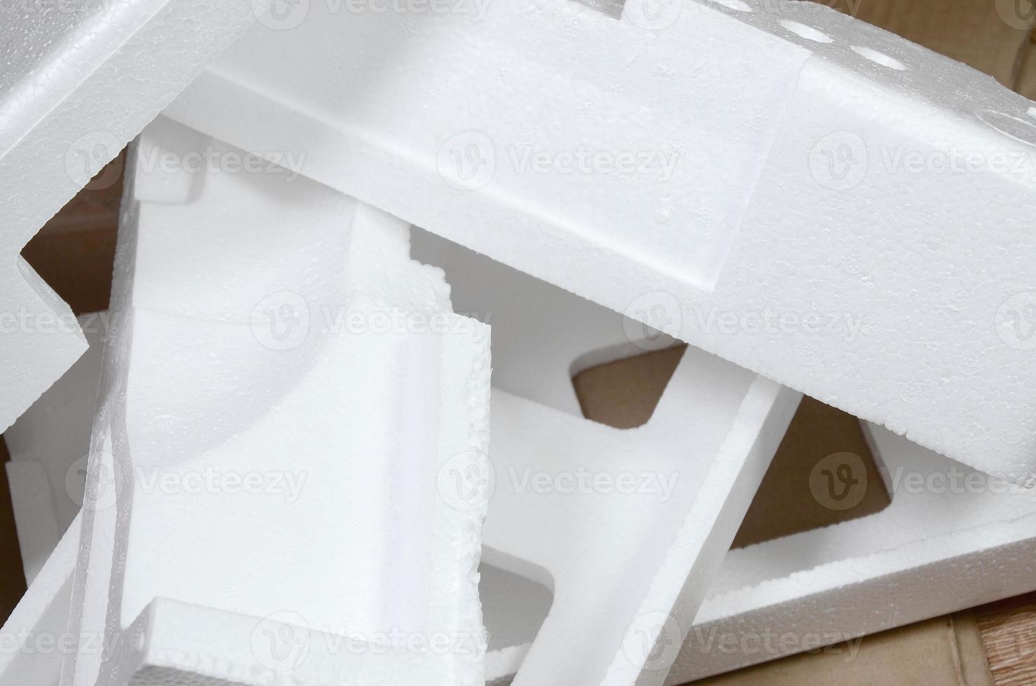 Background image with beige cardboard paper and styrofoam boxes disgarded as rubbish. The concept of unpacking new home appliances out of the carton box photo