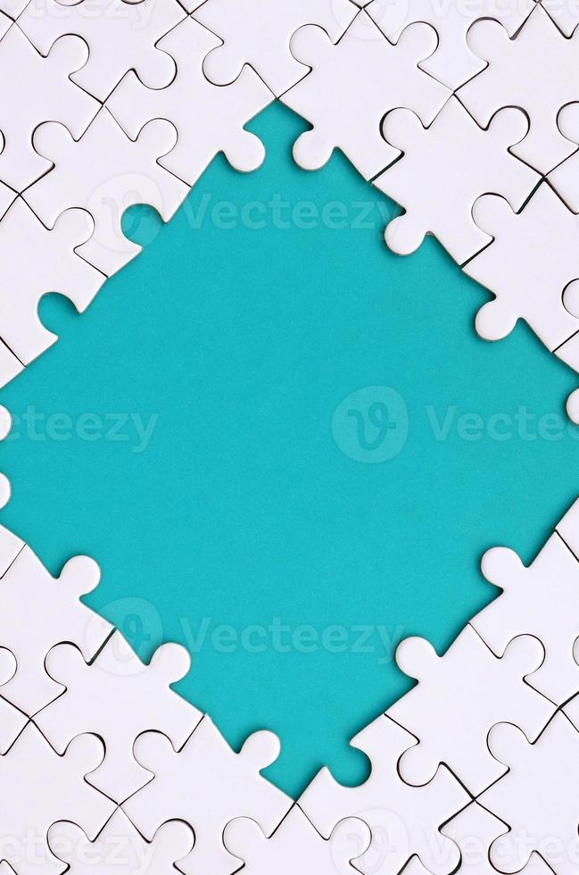 Framing in the form of a rhombus, made of a white jigsaw puzzle around the blue space photo