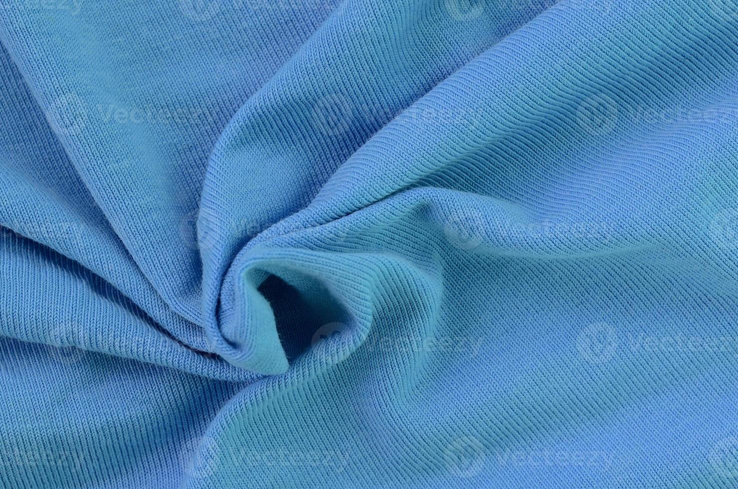 The texture of the fabric in blue color. Material for making shirts and blouses photo
