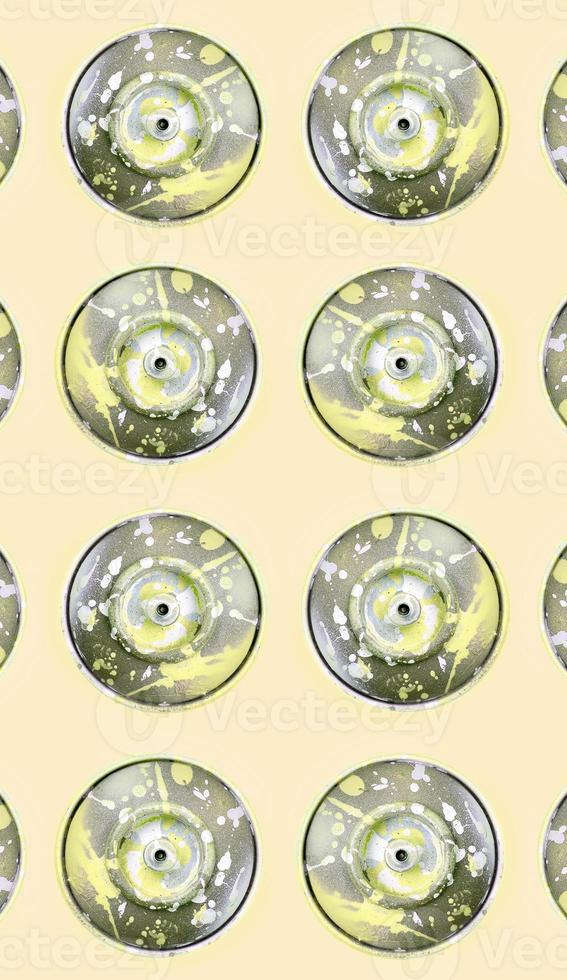 Many used spray cans for graffiti drawing lies on a pastel colored backgroung. Street art painting concept. Minimal flat lay pattern. Top view photo