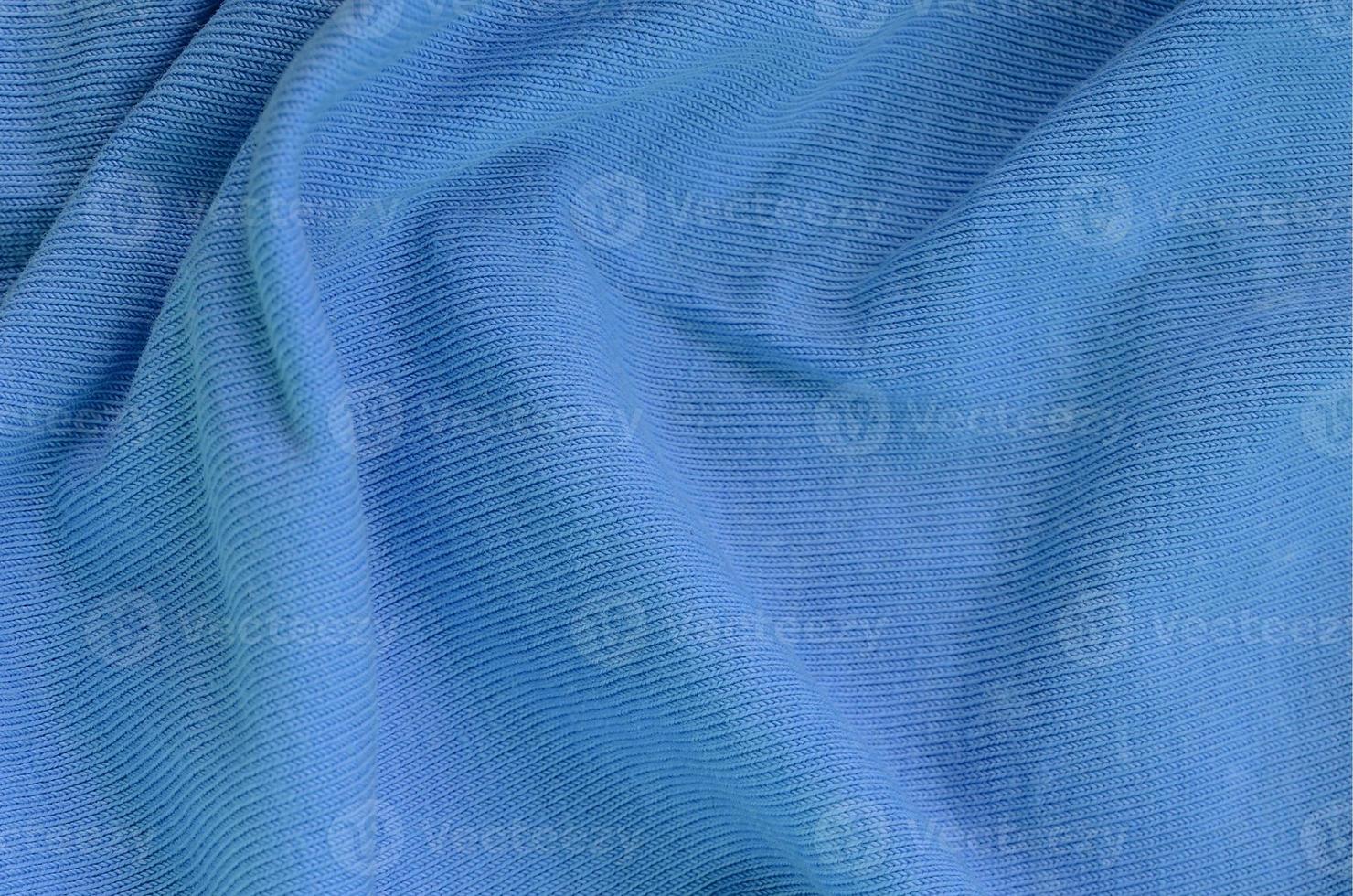 The texture of the fabric in blue color. Material for making shirts and blouses photo