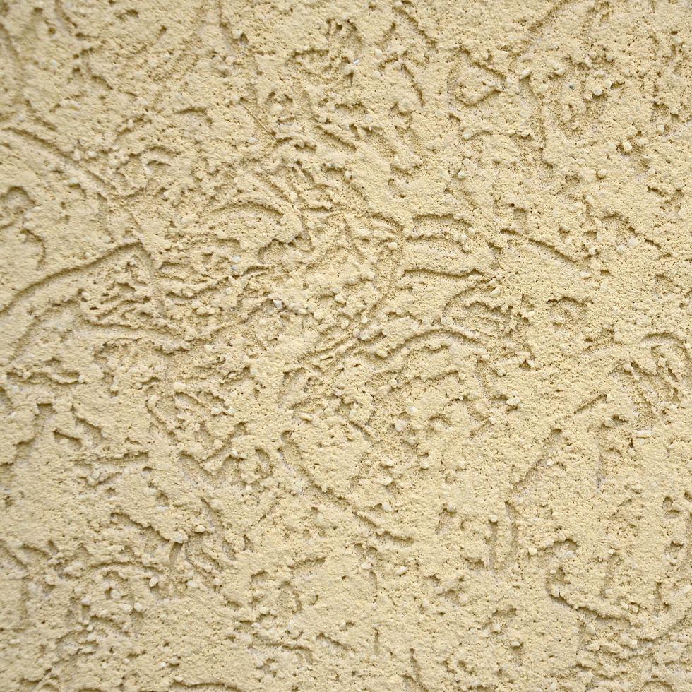 The texture of the beige decorative plaster in bark beetle style photo
