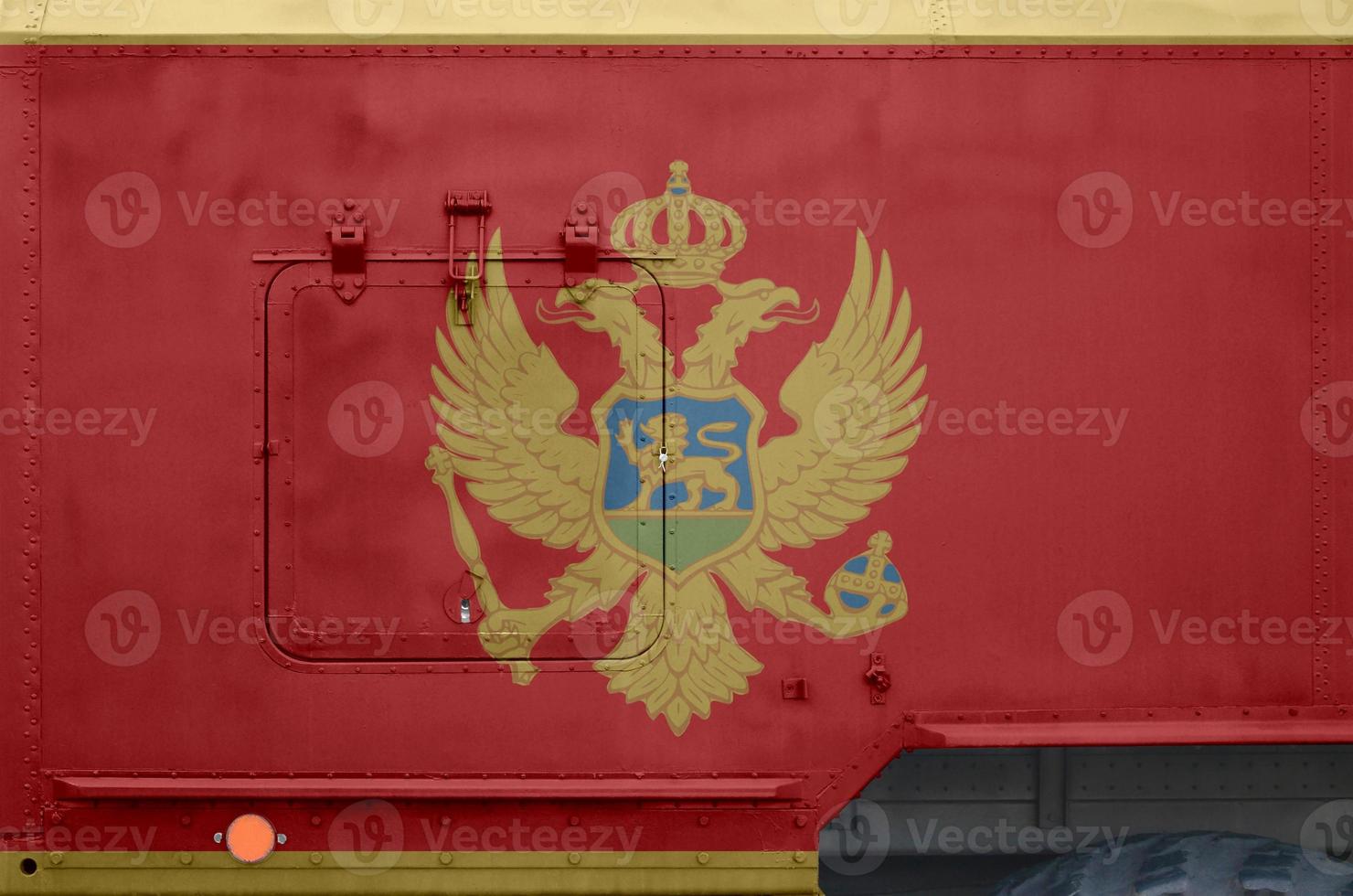 Montenegro flag depicted on side part of military armored truck closeup. Army forces conceptual background photo