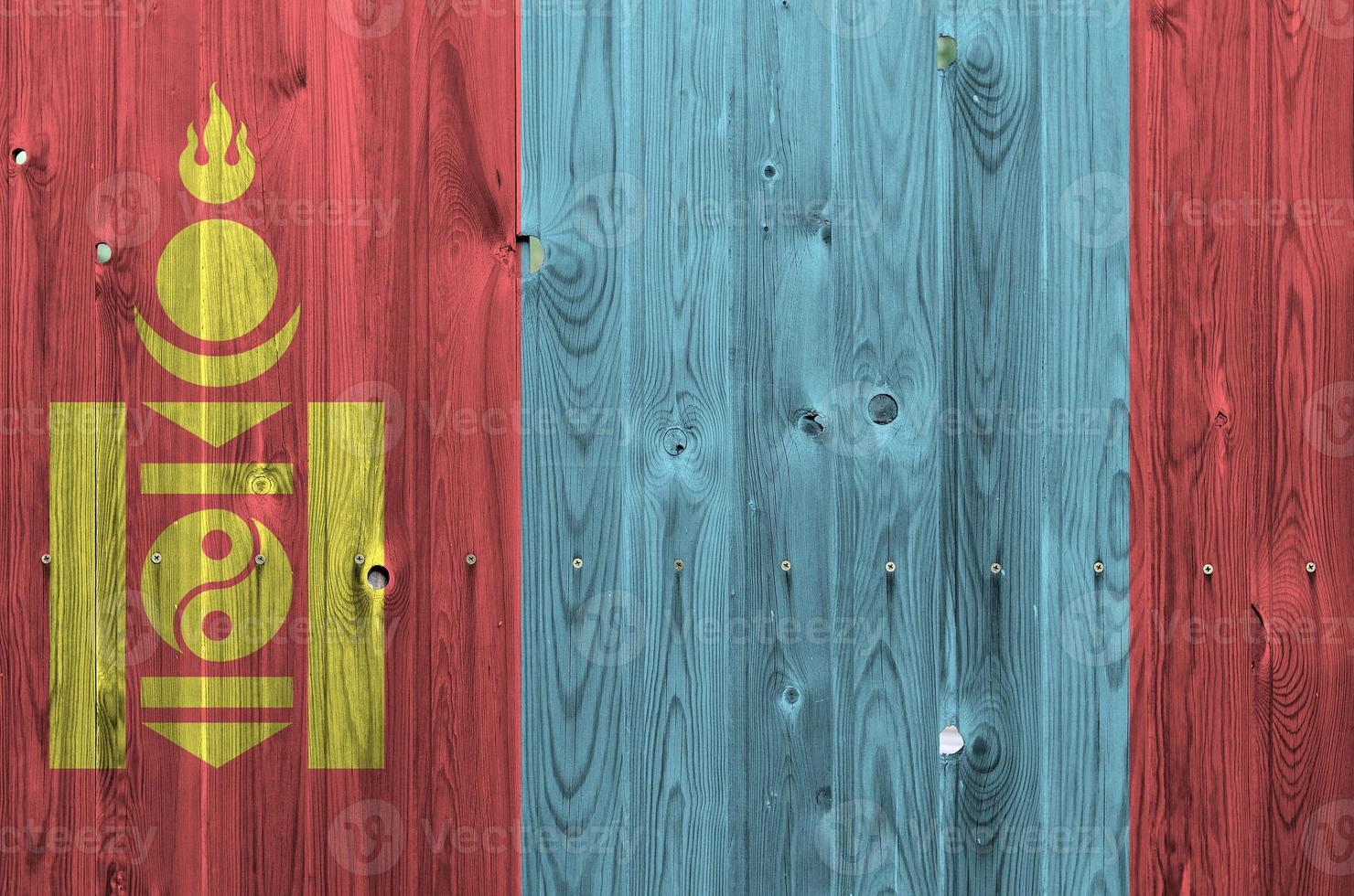Mongolia flag depicted in bright paint colors on old wooden wall. Textured banner on rough background photo