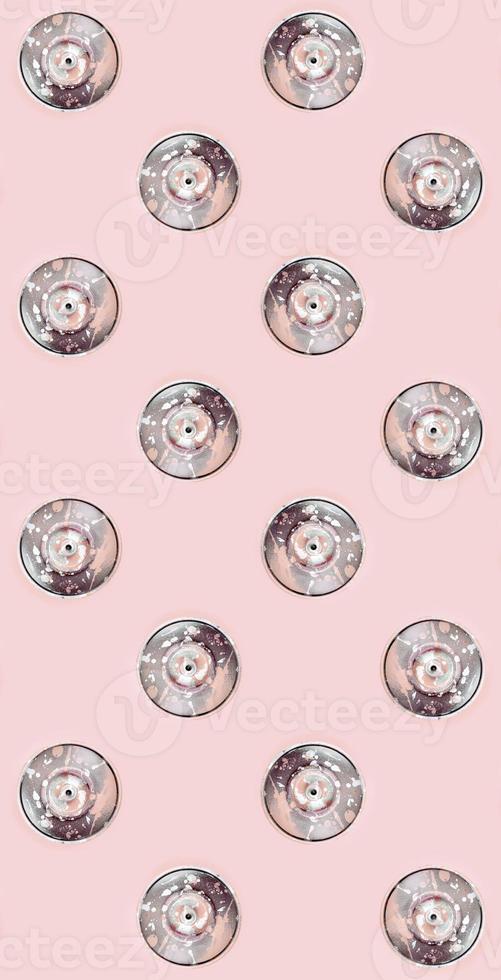 Many used spray cans for graffiti drawing lies on a pastel colored backgroung. Street art painting concept. Minimal flat lay pattern. Top view photo