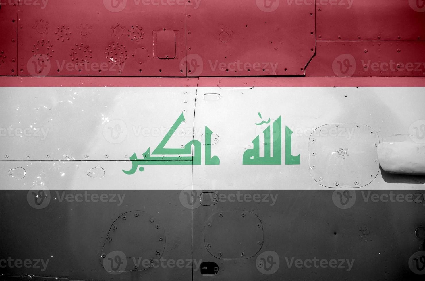 Iraq flag depicted on side part of military armored helicopter closeup. Army forces aircraft conceptual background photo