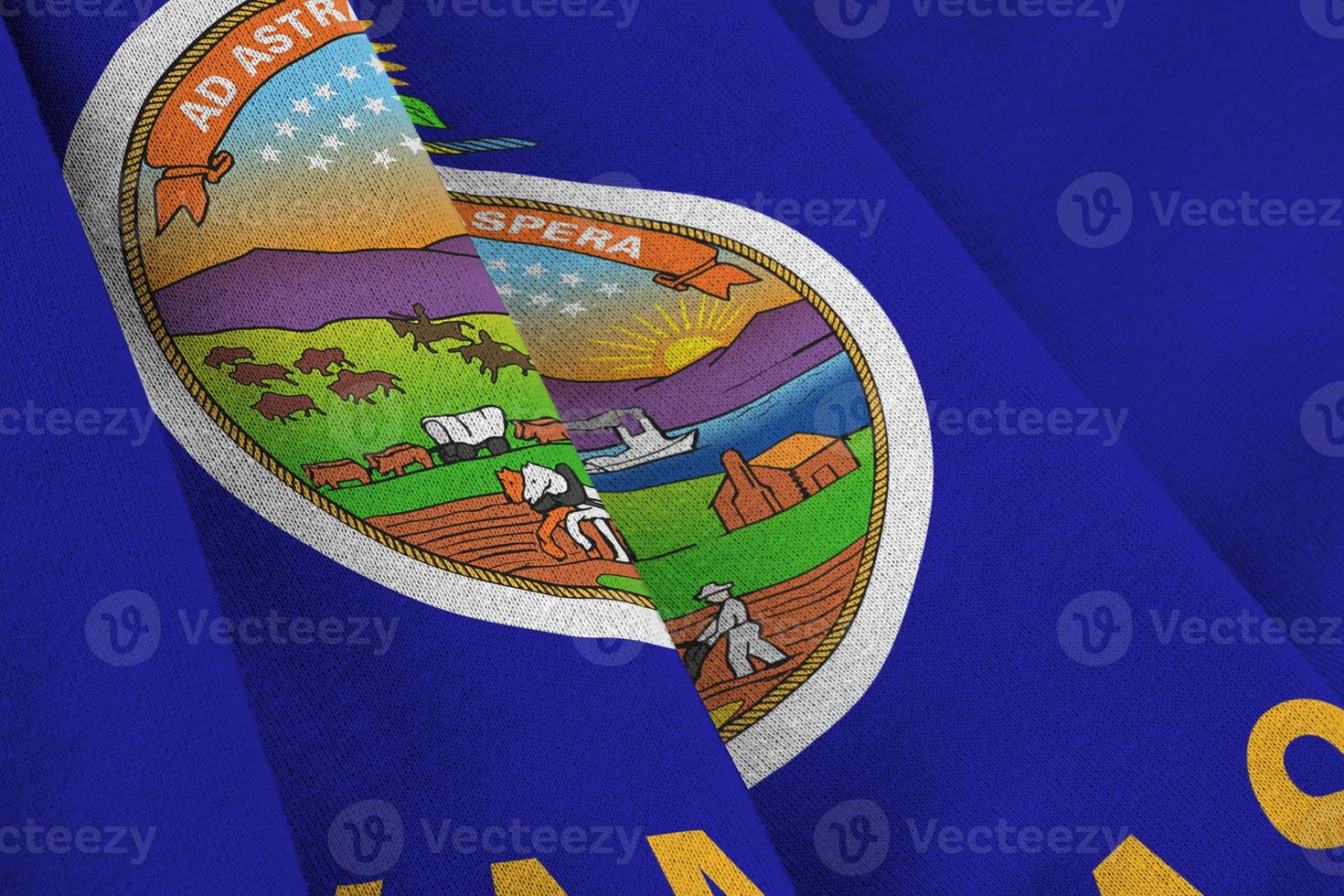 Kansas US state flag with big folds waving close up under the studio light indoors. The official symbols and colors in banner photo