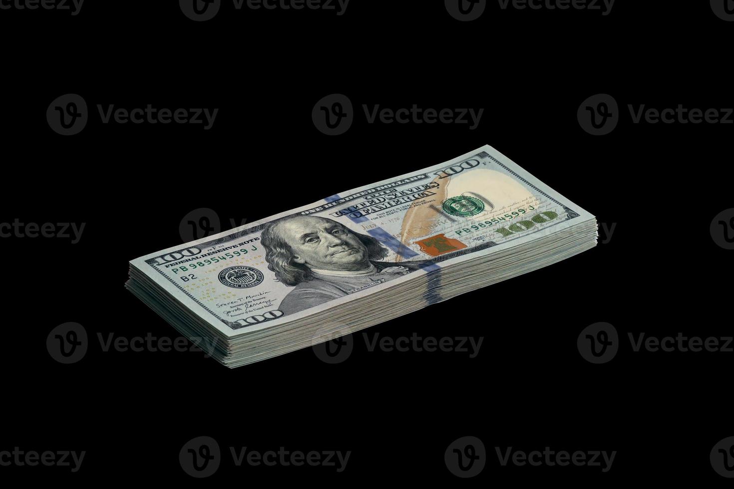 Bundle of US dollar bills isolated on black. Pack of american money with high resolution on perfect black background photo