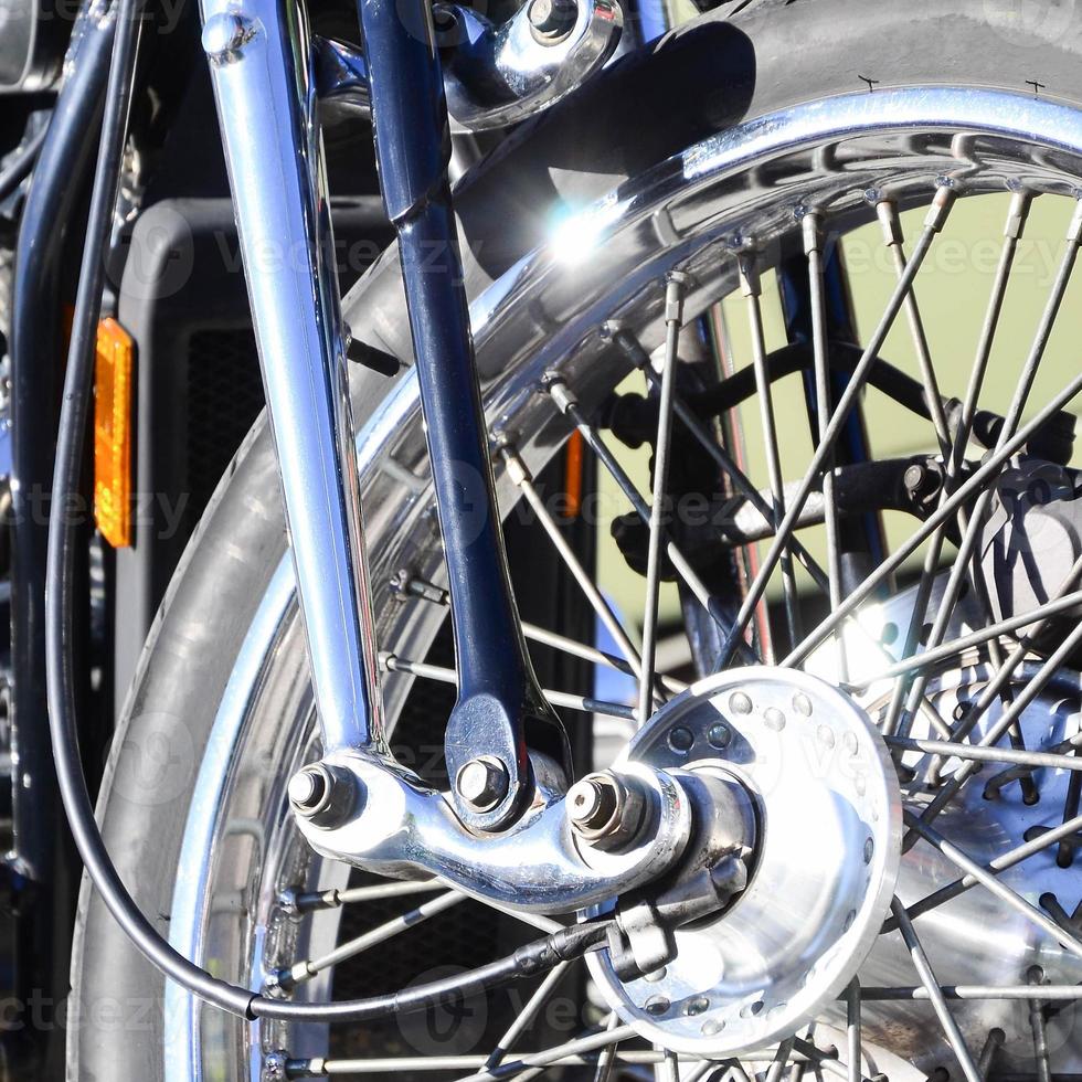 Fragment of chromed shiny wheel of old classic motorbike photo