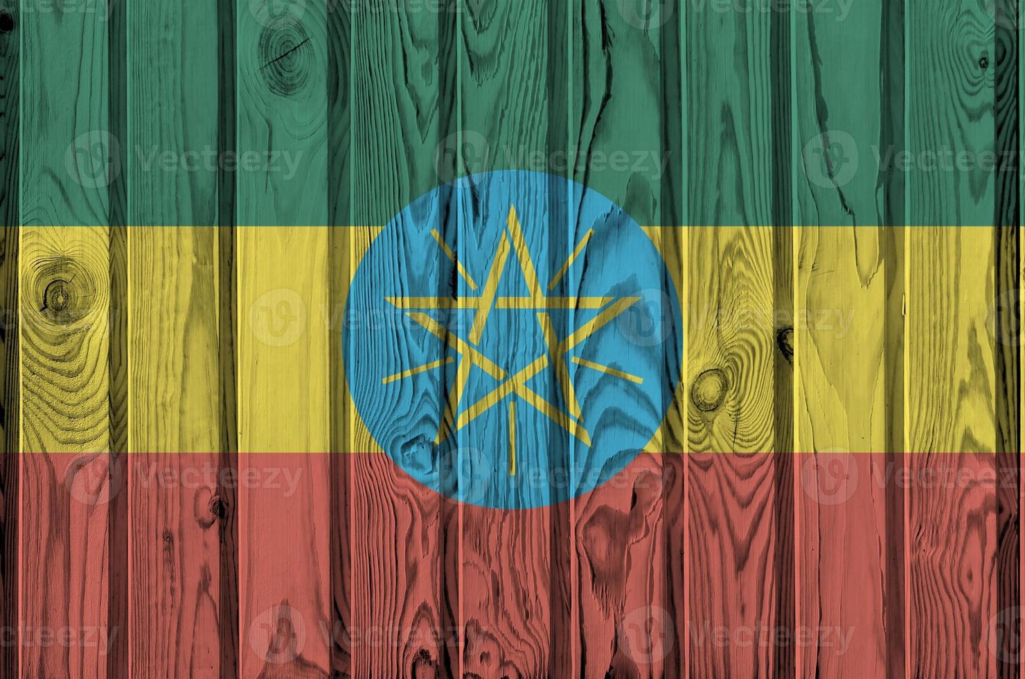 Ethiopia flag depicted in bright paint colors on old wooden wall. Textured banner on rough background photo
