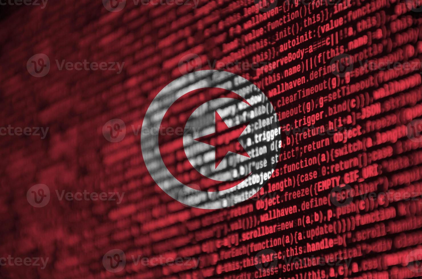 Tunisia flag  is depicted on the screen with the program code. The concept of modern technology and site development photo