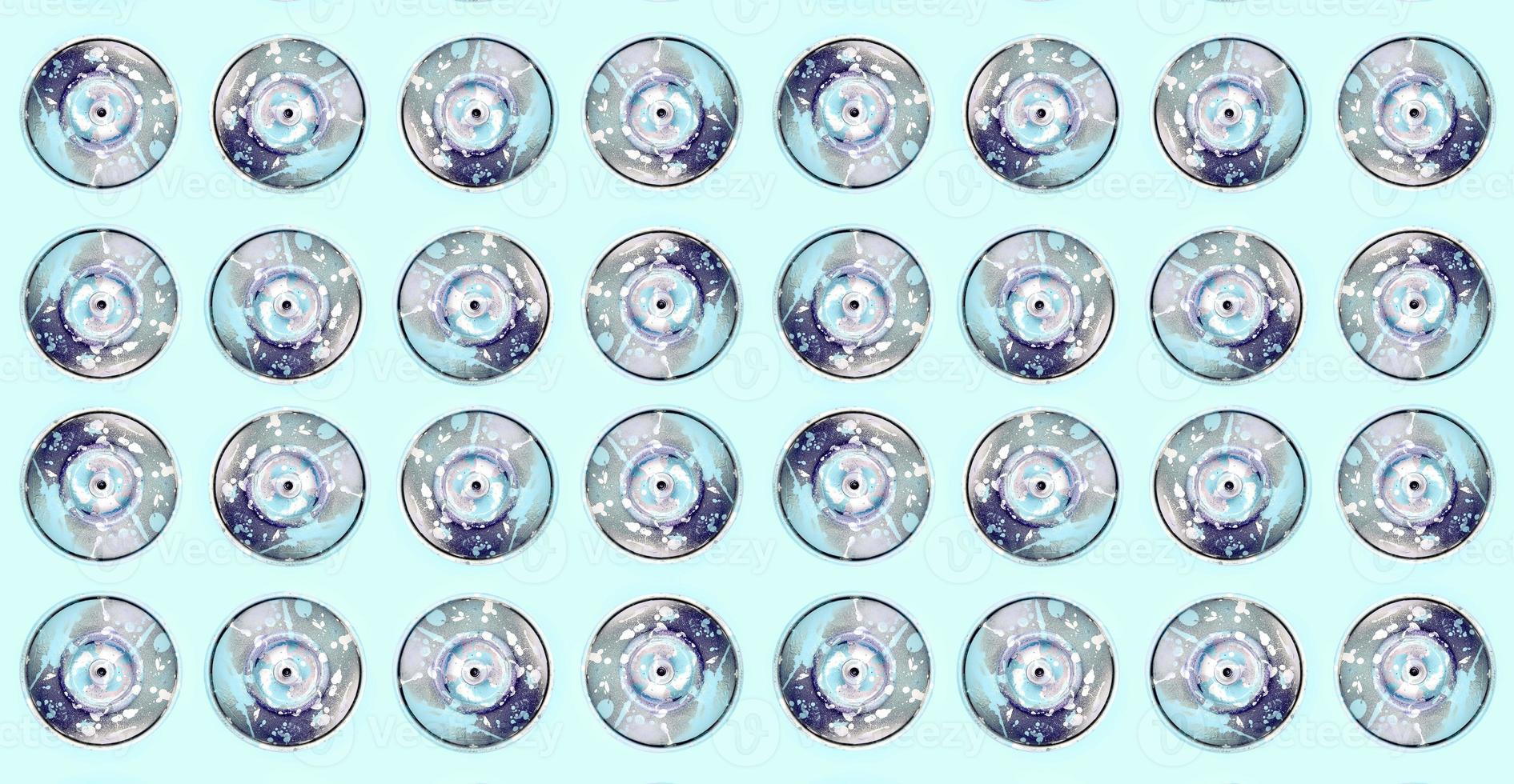 Many used spray cans for graffiti drawing lies on a pastel colored backgroung. Street art painting concept. Minimal flat lay pattern. Top view photo