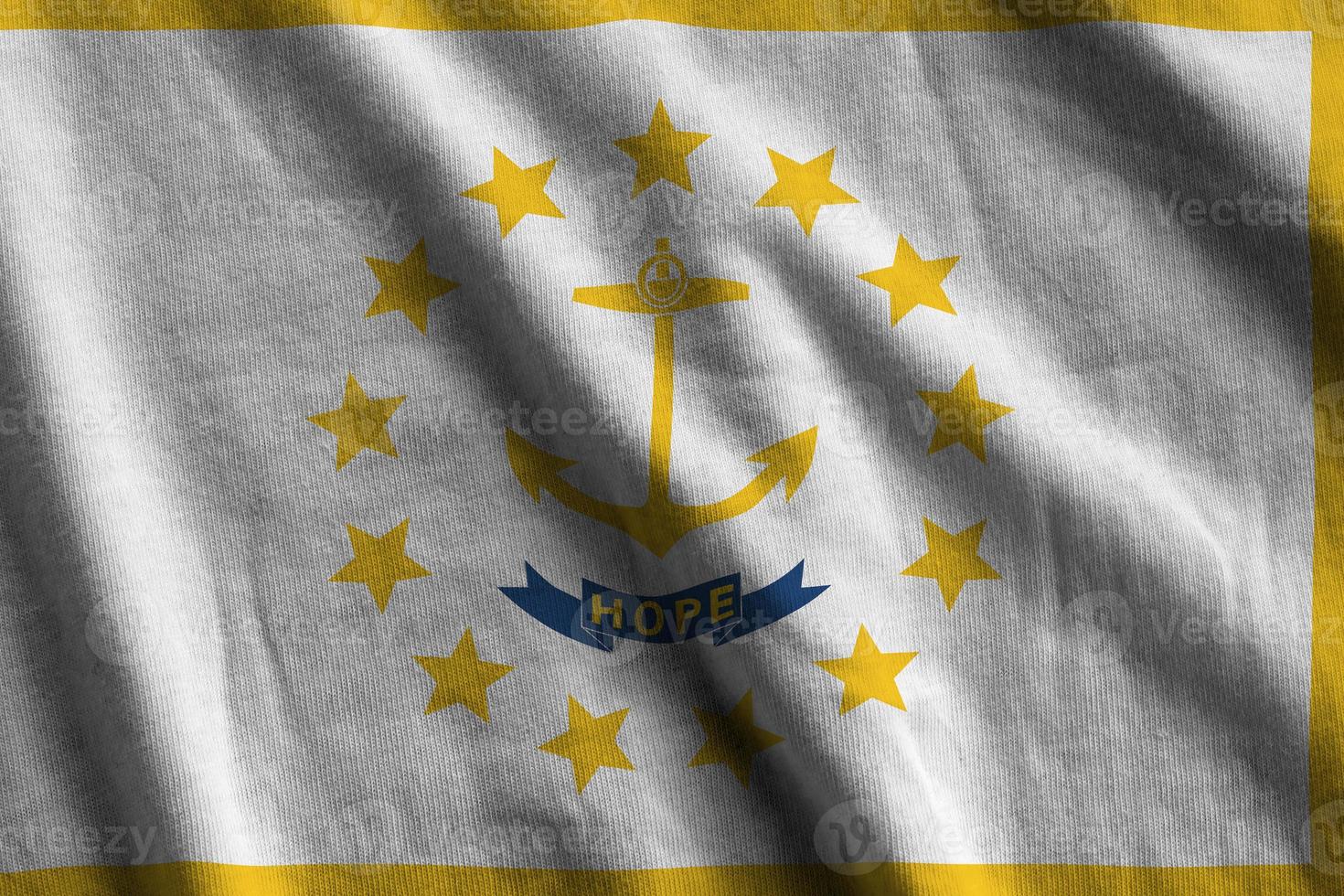 Rhode Island US state flag with big folds waving close up under the studio light indoors. The official symbols and colors in banner photo