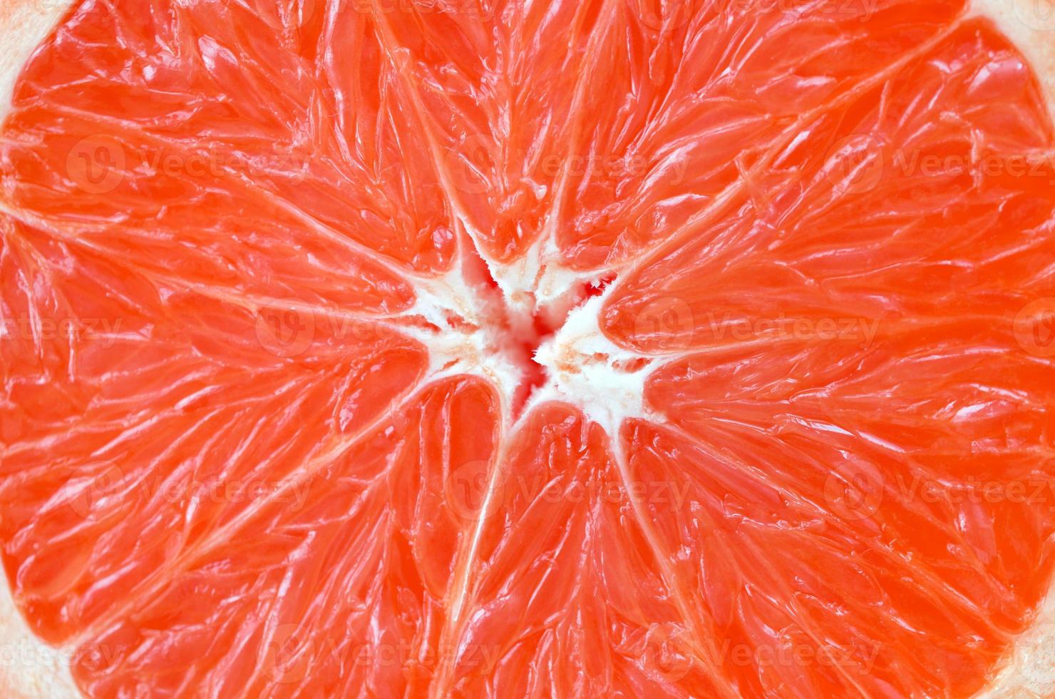 Top view of a fragment of the grapefruit slice close up. Macro background texture photo