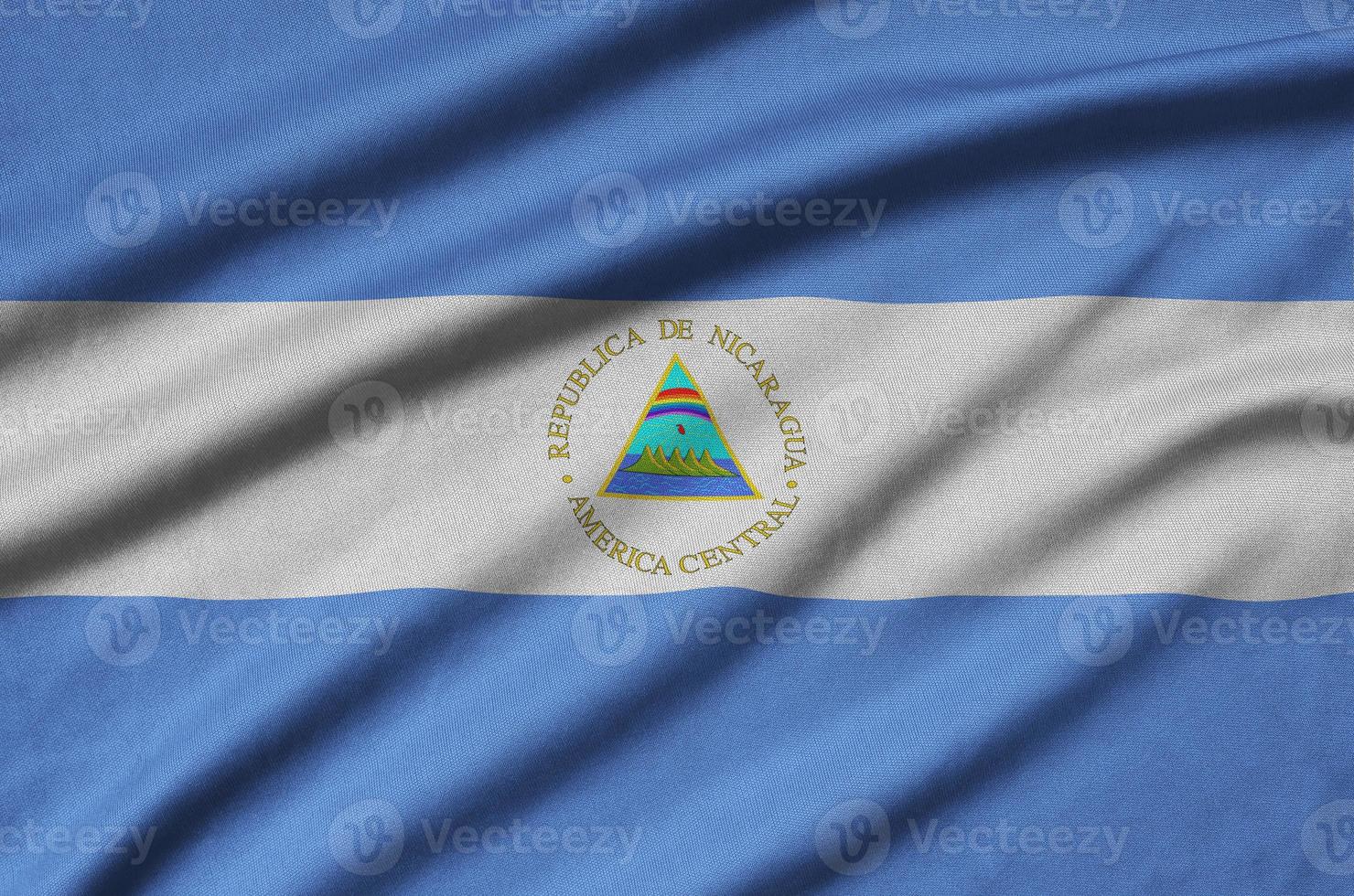Nicaragua flag  is depicted on a sports cloth fabric with many folds. Sport team banner photo