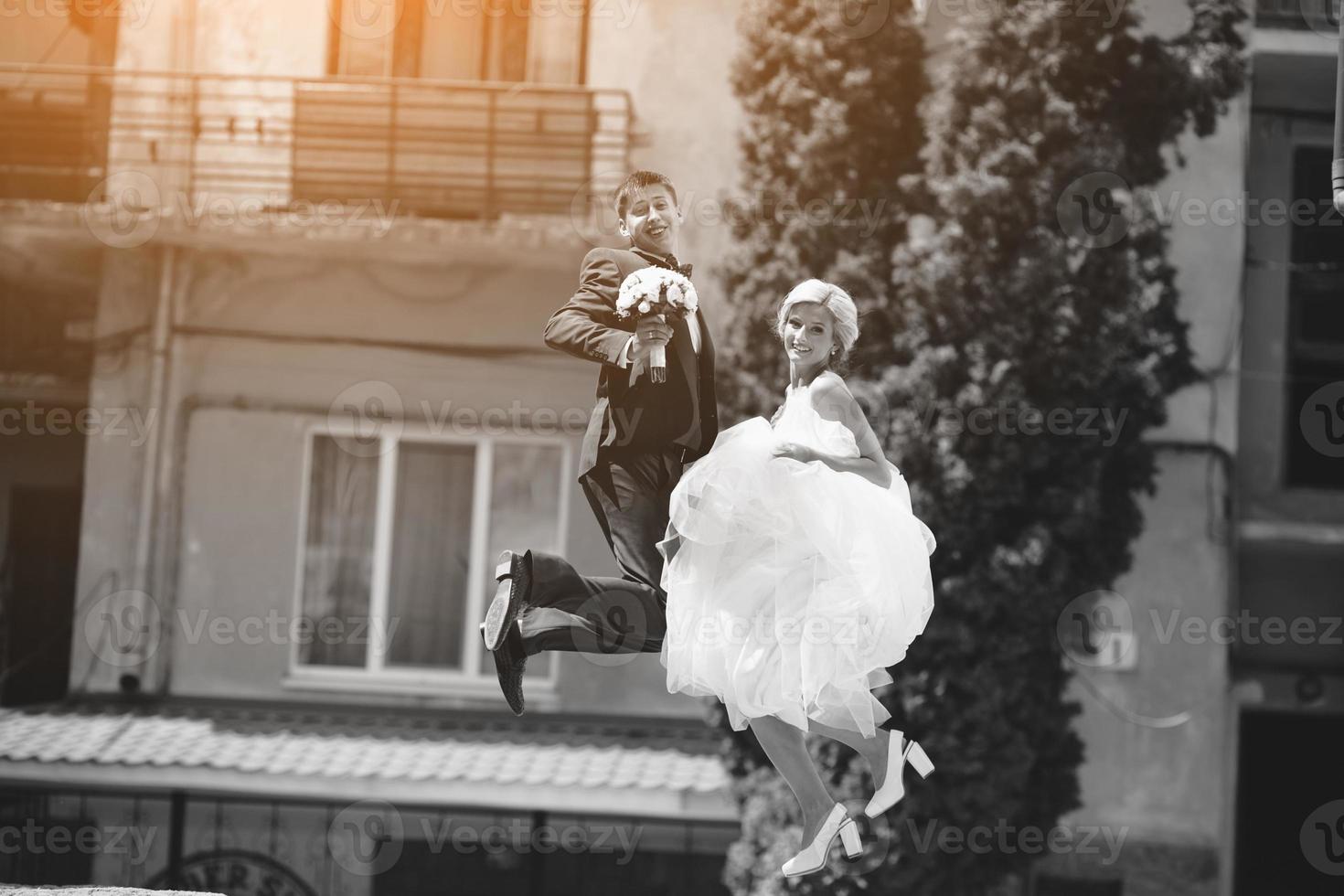 couple jumping on the street photo