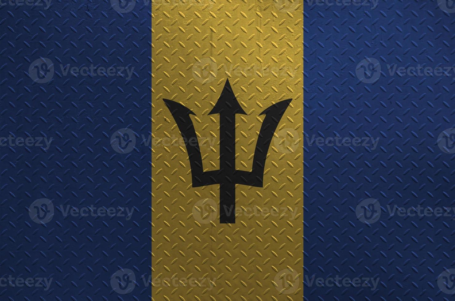 Barbados flag depicted in paint colors on old brushed metal plate or wall closeup. Textured banner on rough background photo